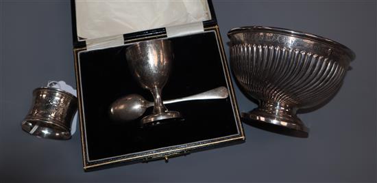 A late Victorian silver christening bowl, a cased egg cup and spoon set and a napkin ring.